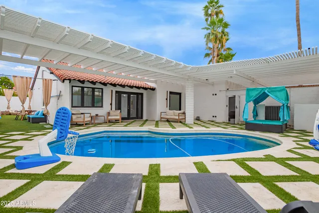 a view of swimming pool with outdoor seating and yard