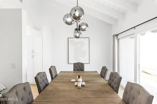 a dining room with furniture and wooden floor