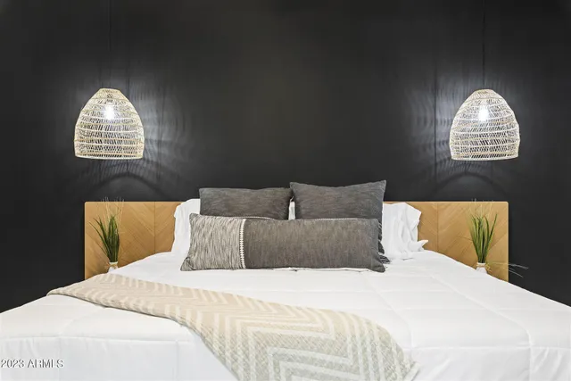 a bedroom with a bed and a chandelier