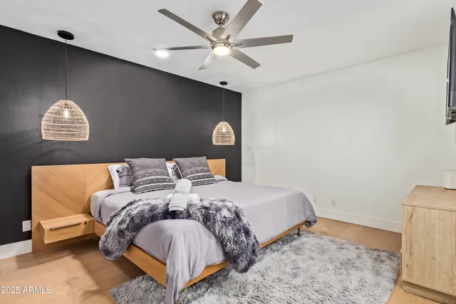 a bedroom with a bed and a wall painting