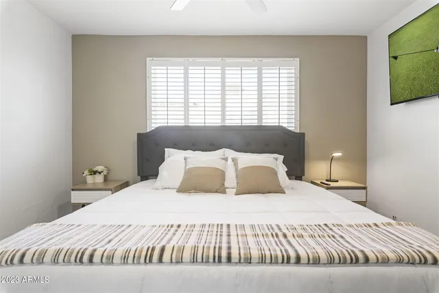 a bedroom with a bed and a window