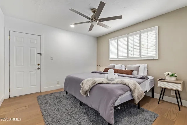 a bedroom with two beds and a chandelier