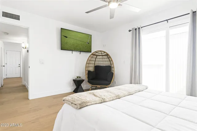 a bedroom with a bed and a mirror