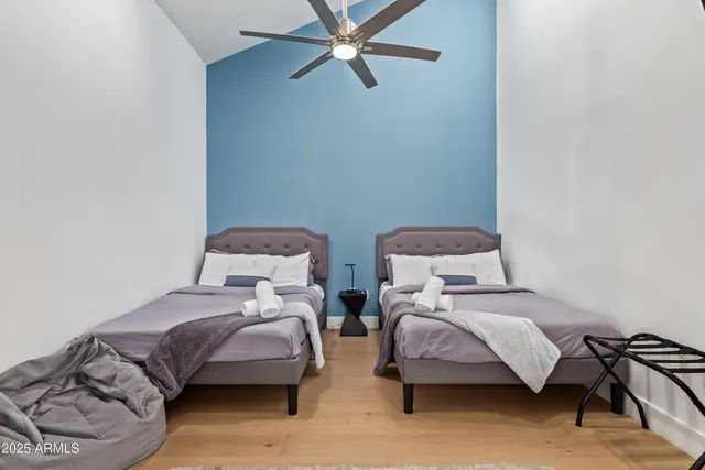 a bedroom with two beds and a dresser