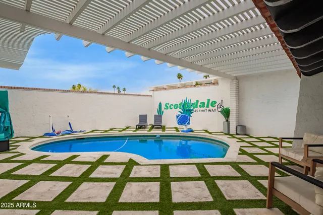 a swimming pool with outdoor seating and yard