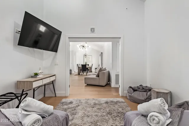 a view of a dining room with furniture wooden floor and a chandelier