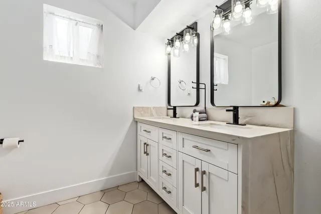 a bathroom with a double vanity sink and a mirror