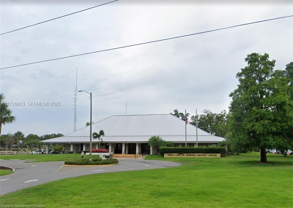 8637 Primavera Street Sebring, FL 33872 - Photo 18 of 27 a front view of a building with garden