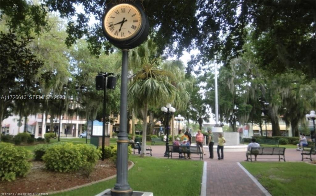 8637 Primavera Street Sebring, FL 33872 - Photo 25 of 27 a view of a park with a slide and large trees