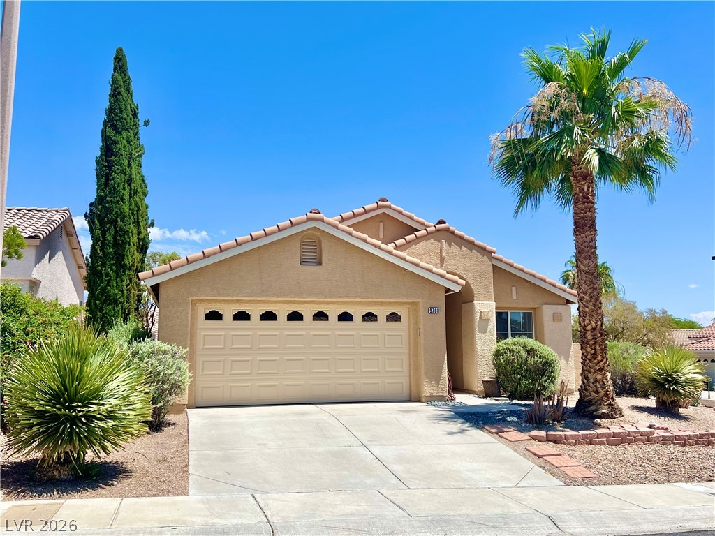 9708 Ridge Creek Place Las Vegas, NV 89134 - Photo 2 of 34 A well-maintained desert home with a tiled roof and inviting curb appeal.