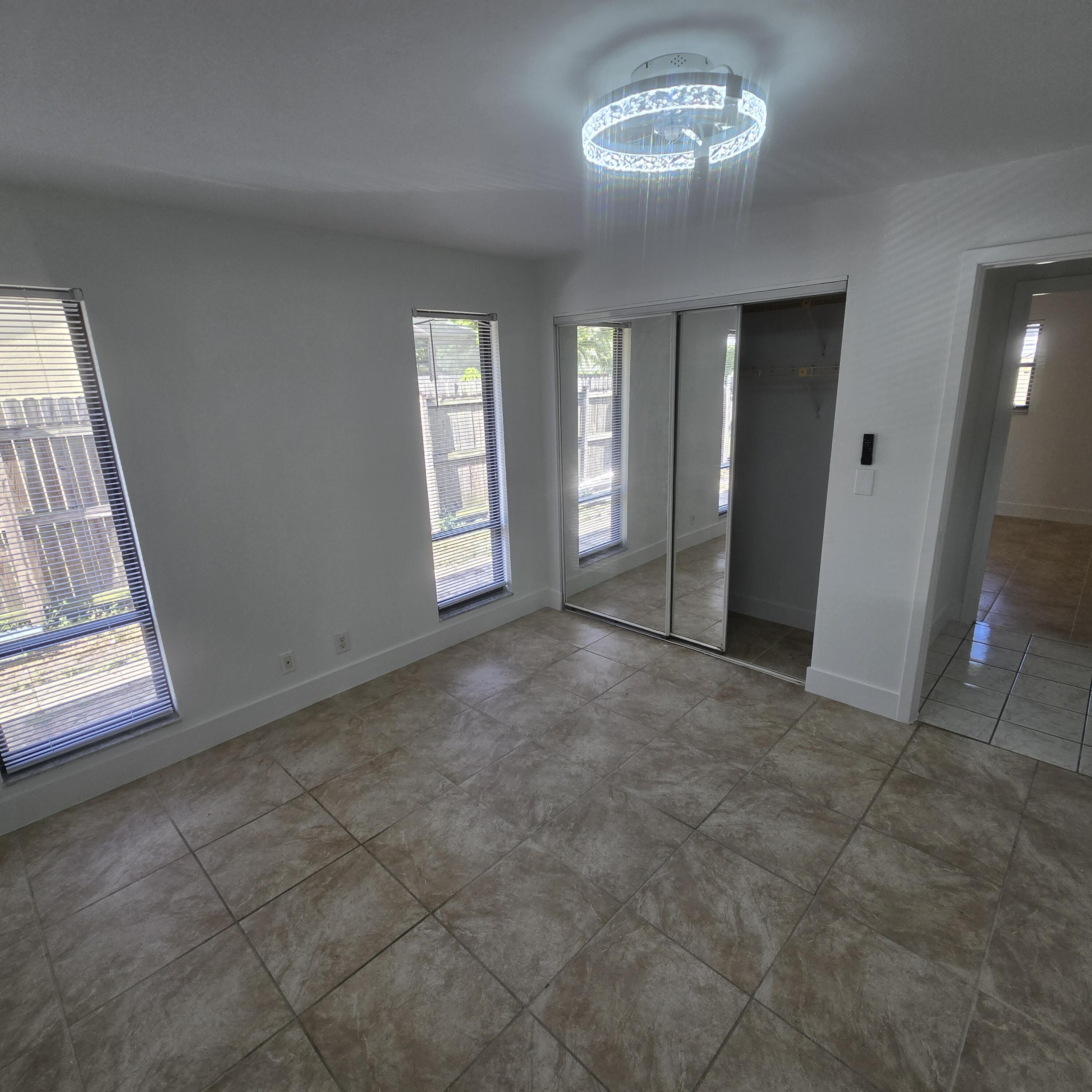 1237 Wynnedale Road, Unit 1237 West Palm Beach, FL 33417 - Photo 12 of 20 a view of an empty room with a window