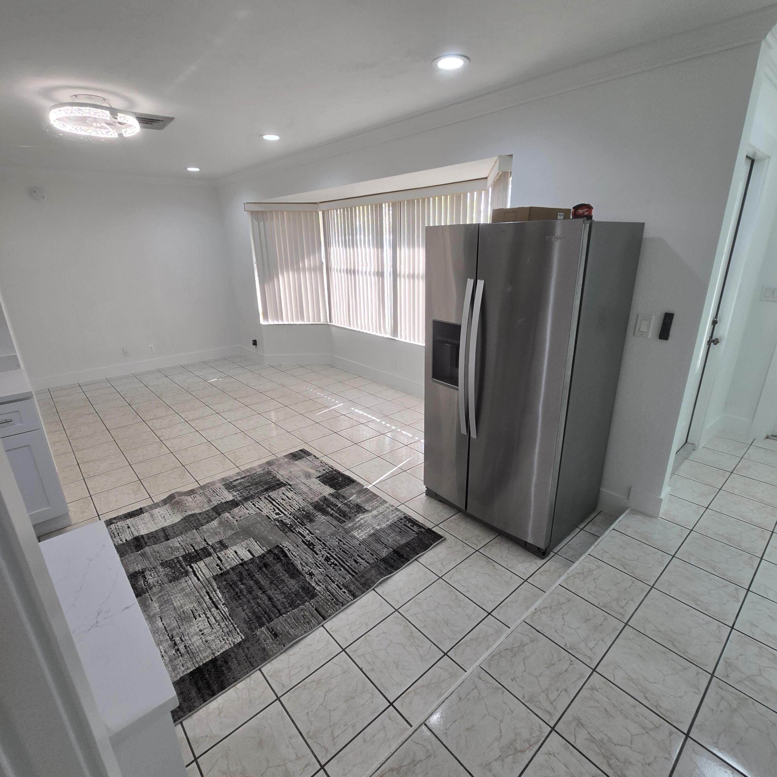 1237 Wynnedale Road, Unit 1237 West Palm Beach, FL 33417 - Photo 18 of 20 a view of a refrigerator in kitchen and a window