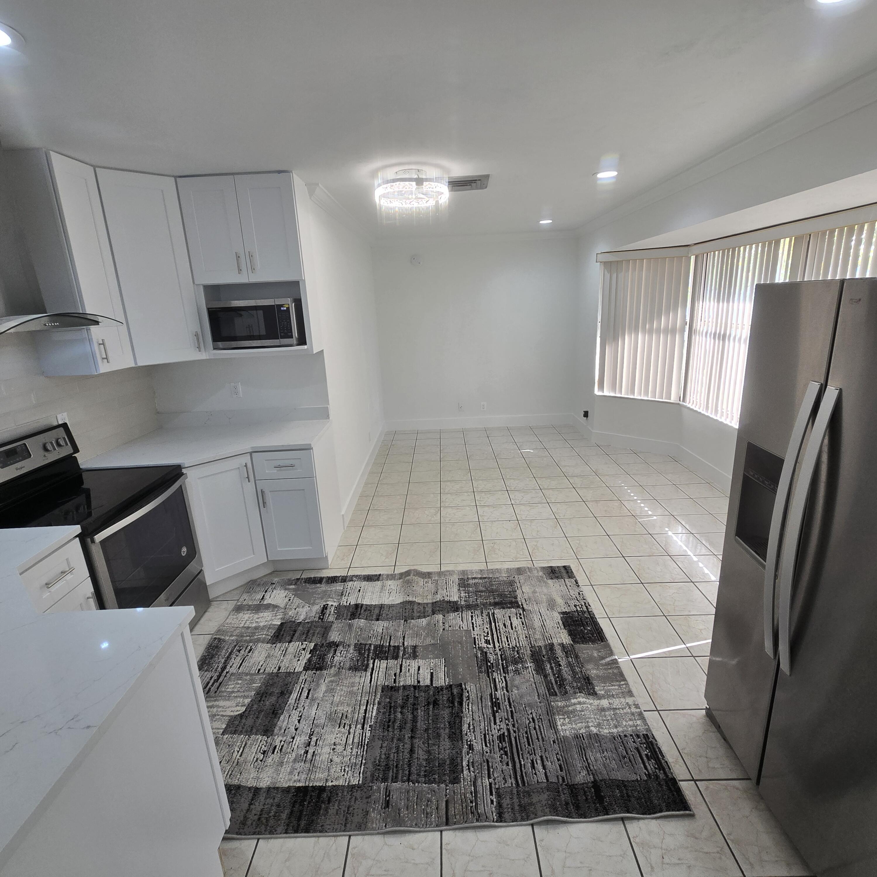 1237 Wynnedale Road, Unit 1237 West Palm Beach, FL 33417 - Photo 4 of 20 a bedroom with a bed and mirror