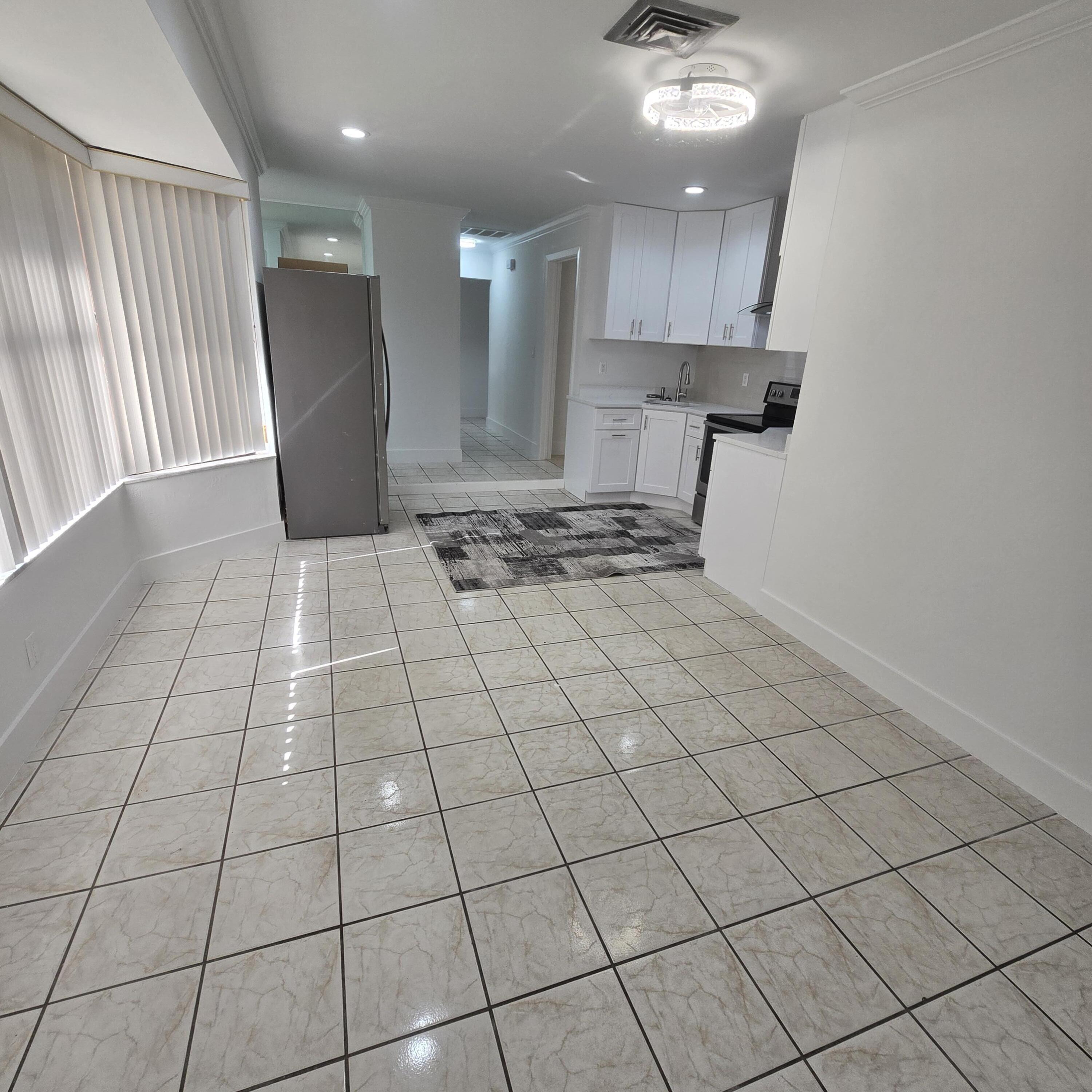 1237 Wynnedale Road, Unit 1237 West Palm Beach, FL 33417 - Photo 5 of 20 a view of a refrigerator and window in a kitchen