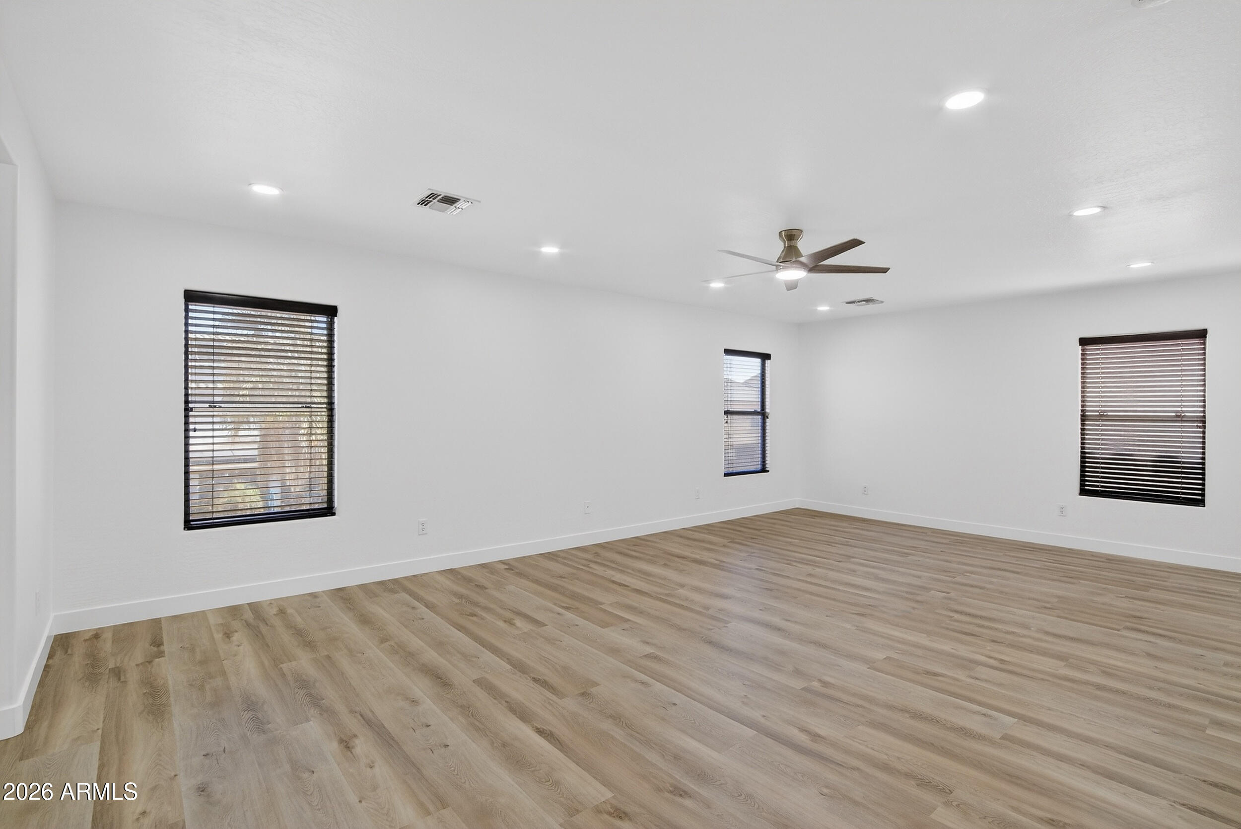 43620 West Cowpath Road Maricopa, AZ 85138 - Photo 30 of 60 an empty room with windows and ceiling fan