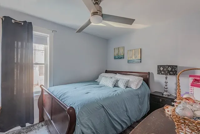 a living room with furniture potted plant and a large window