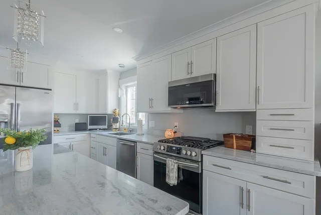 a bathroom with cabinets granite counter tops and a sink