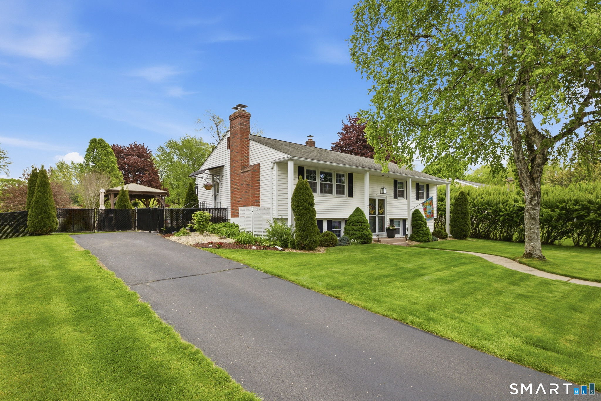 7 Stardust Drive Enfield, CT 06082 - Photo 38 of 38 a front view of a house with a yard and trees