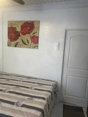 a bathroom with a painting on the wall and a window