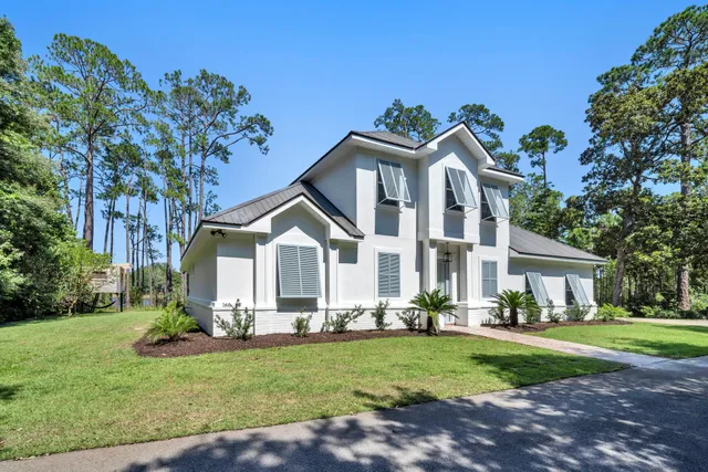 a large kitchen with stainless steel appliances a large center island and a wooden floor