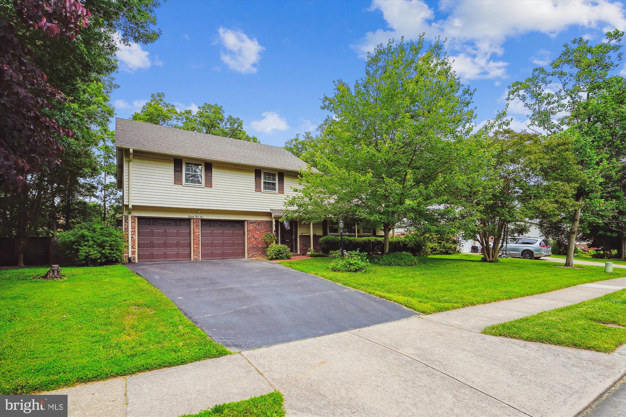 a view of a house with a yard and tree s