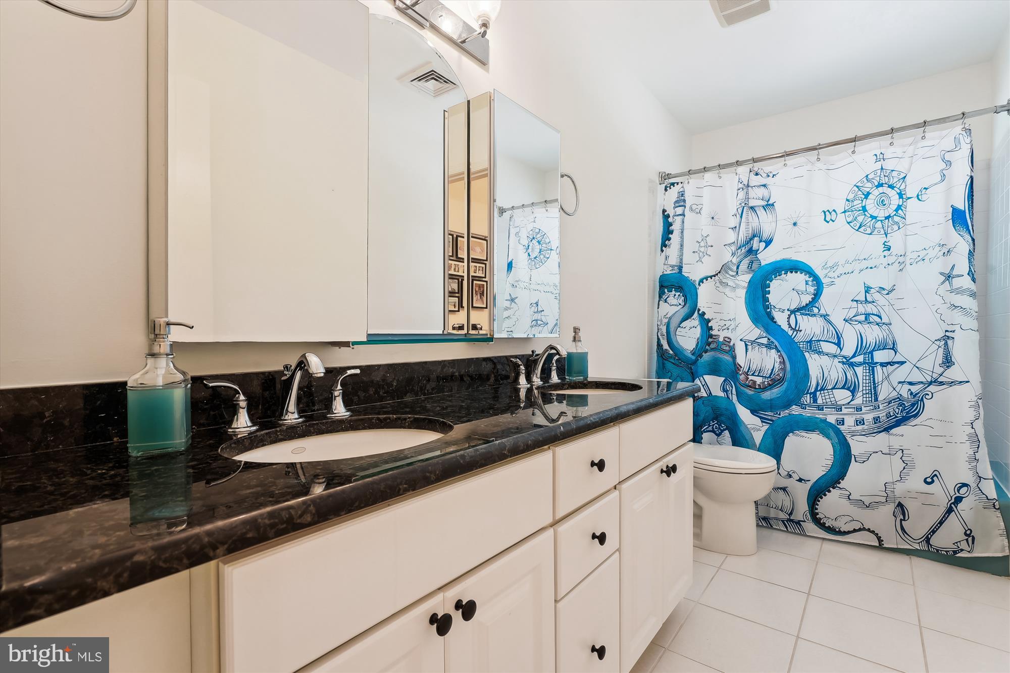 8510 Oakford Drive Springfield, VA 22152 - Photo 29 of 36 a bathroom with a granite countertop sink and a mirror