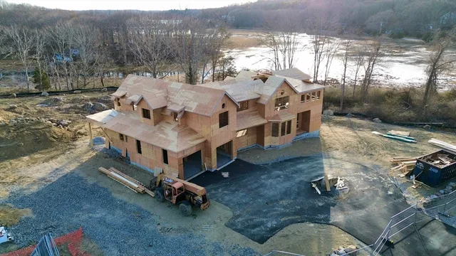 a roof deck with couch and chairs