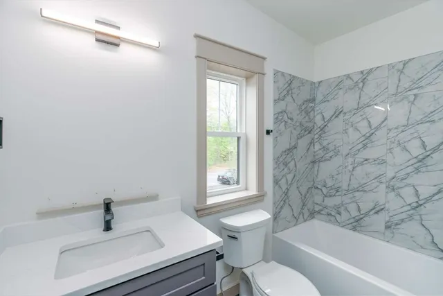 a bathroom with a sink a toilet and bathtub