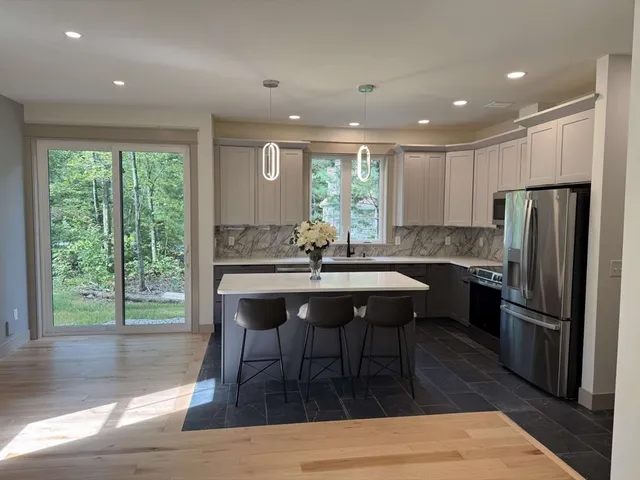 a kitchen with a sink appliances and cabinets