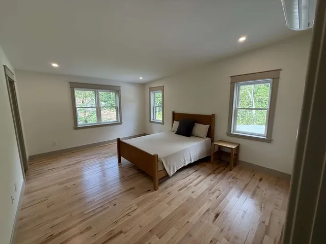 a bedroom with a bed and window