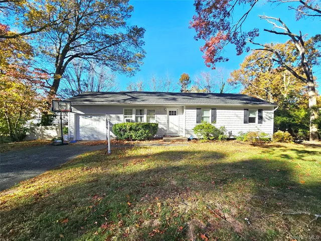 a view of a house with pool and a yard