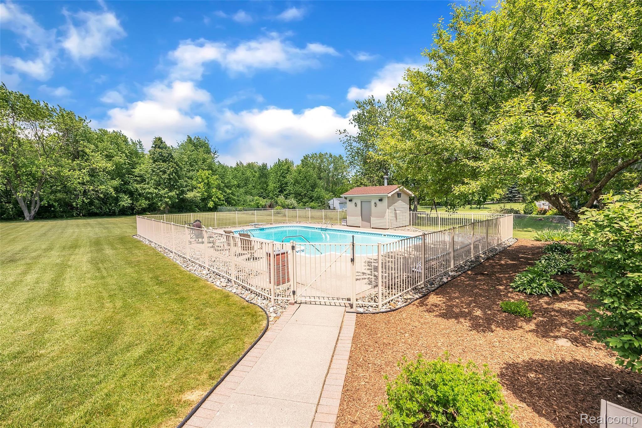 4054 Bennett Lake Road Fenton, MI 48430 - Photo 38 of 57 20x40 Heated Inground Pool with Aluminum Fencing and Childproof Gate ~ River Rock & Brick Paved Border
