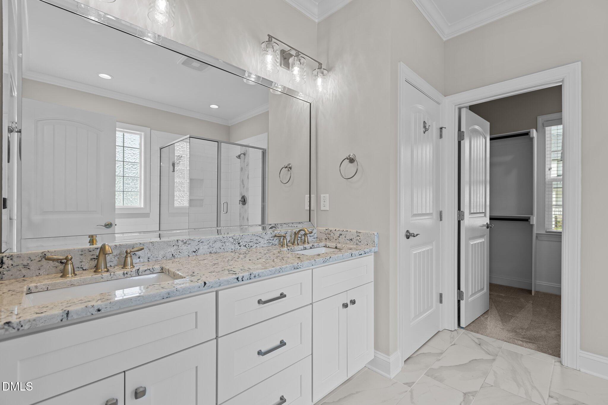 2923 Logan Valley Path Apex, NC 27502 - Photo 12 of 20 a spacious bathroom with a granite countertop sink mirror and shower