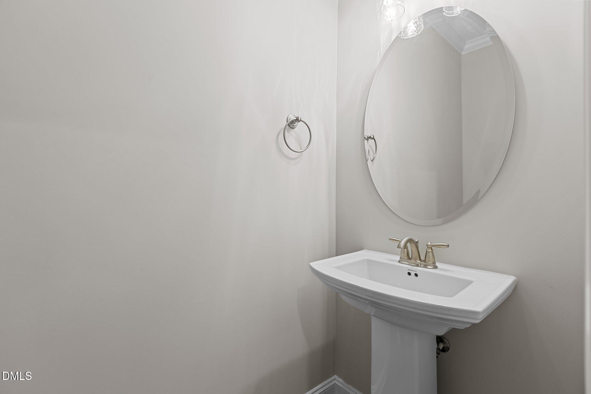 2923 Logan Valley Path Apex, NC 27502 - Photo 15 of 20 a bathroom with a sink a mirror and vanity