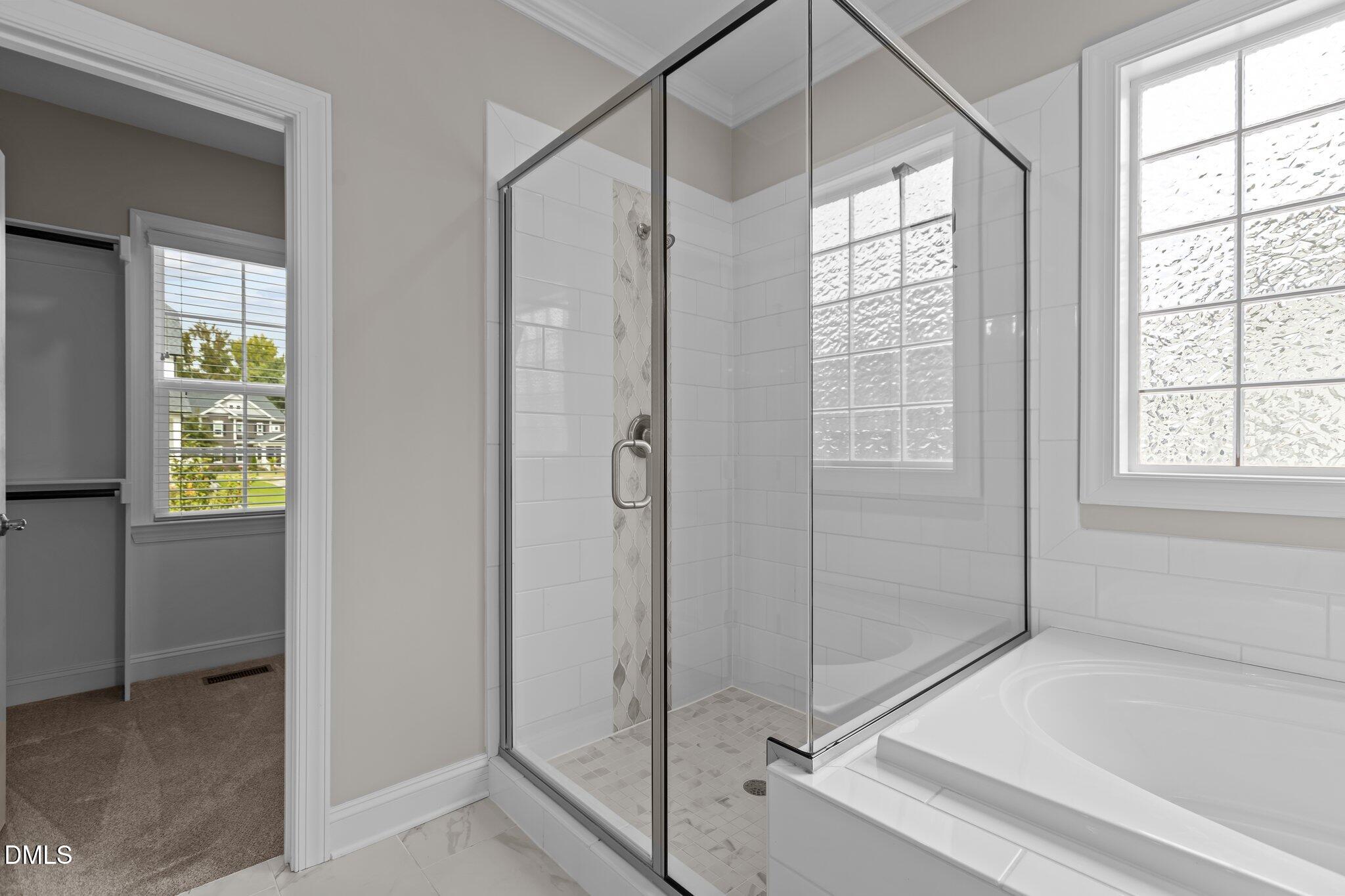 2923 Logan Valley Path Apex, NC 27502 - Photo 17 of 20 a bathroom with a bathtub and a shower
