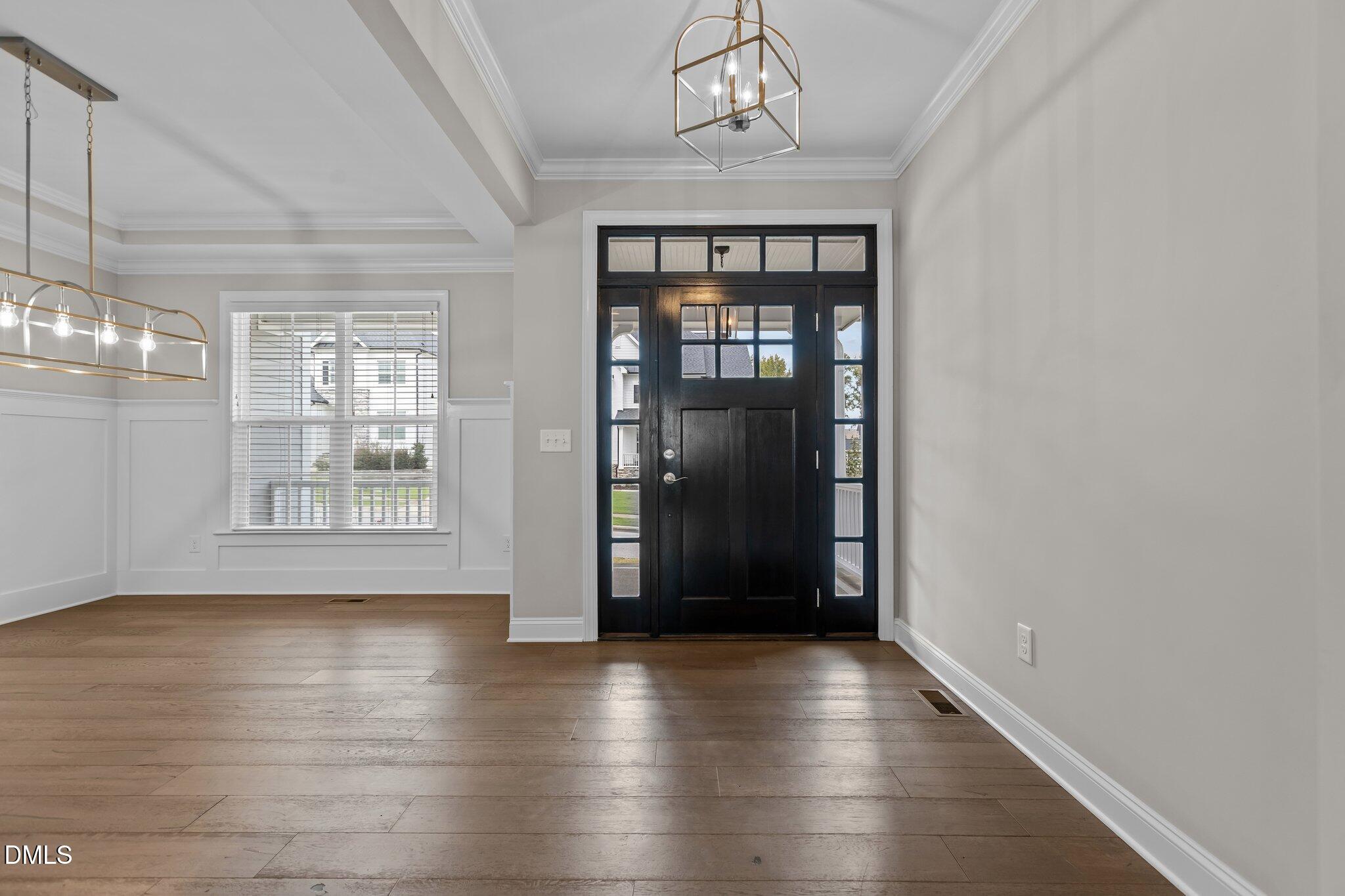 2923 Logan Valley Path Apex, NC 27502 - Photo 2 of 20 a view of an empty room with wooden floor and a window