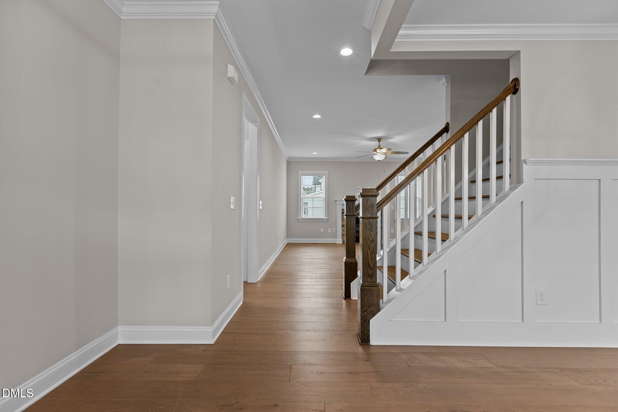 2923 Logan Valley Path Apex, NC 27502 - Photo 3 of 20 a view of staircase with lots of frames on wall and a window