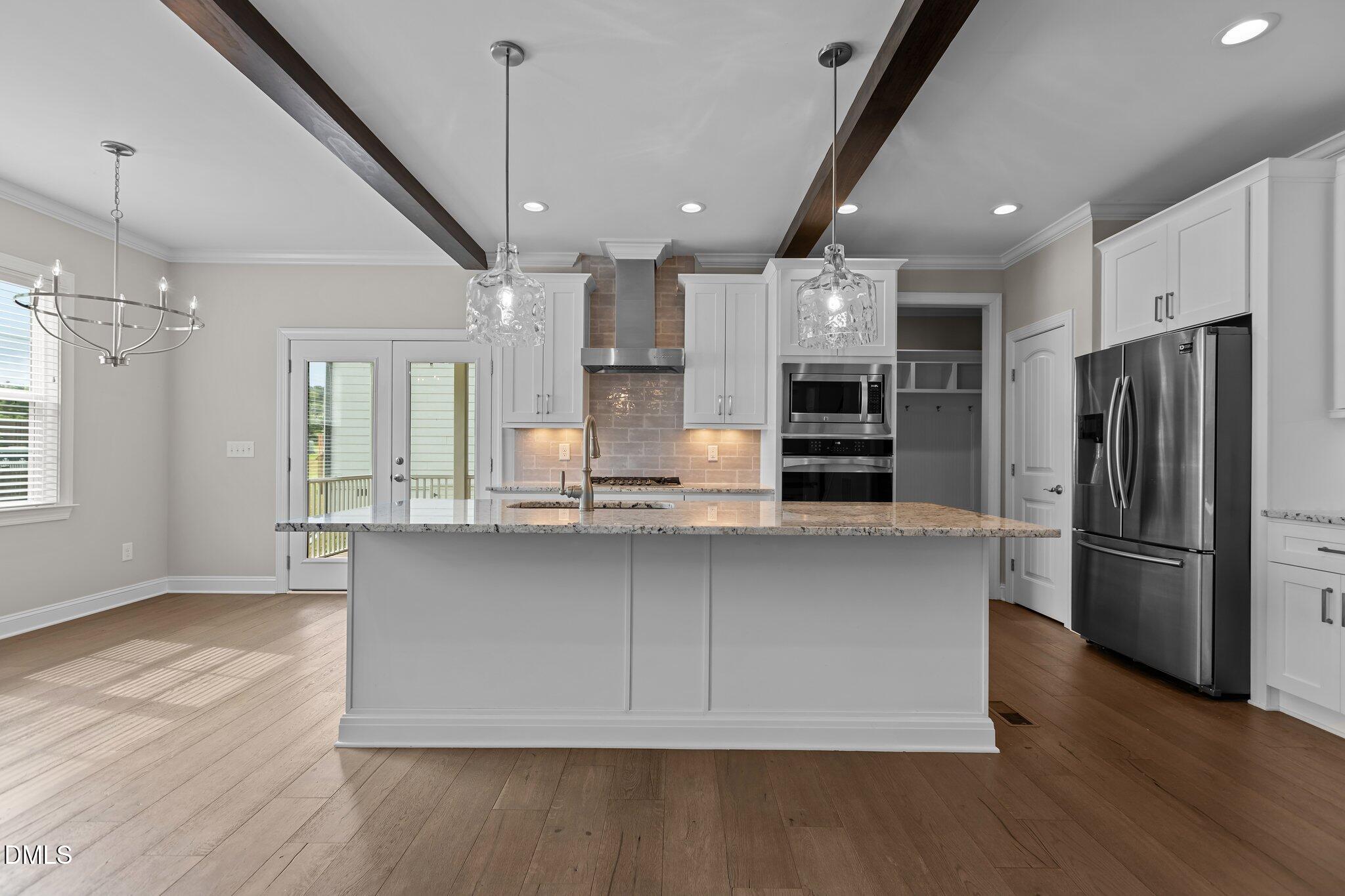 2923 Logan Valley Path Apex, NC 27502 - Photo 7 of 20 a kitchen with stainless steel appliances a refrigerator sink and microwave