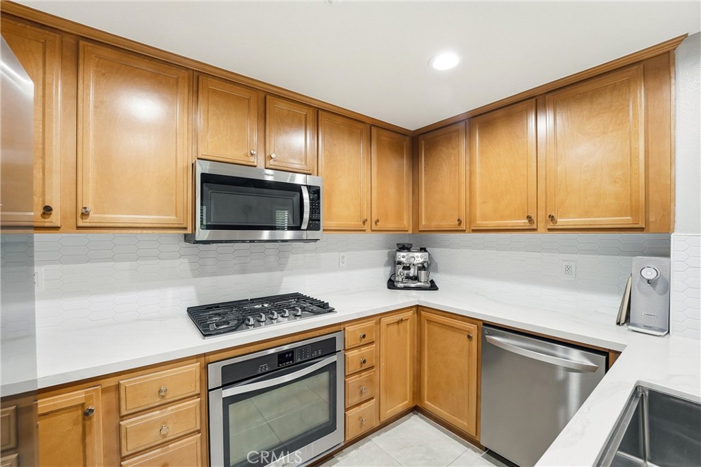 143 Lockford Irvine, CA 92602 - Photo 11 of 43 a kitchen with a sink cabinets and stainless steel appliances
