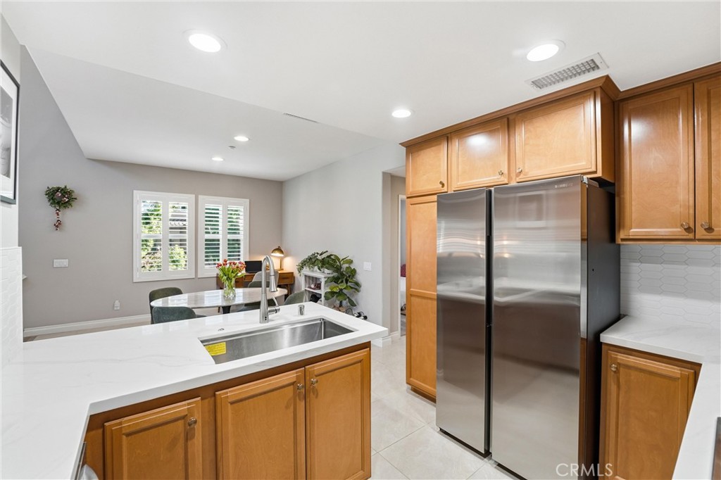 143 Lockford Irvine, CA 92602 - Photo 13 of 43 a kitchen with stainless steel appliances granite countertop a sink refrigerator and window