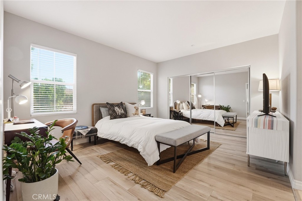 143 Lockford Irvine, CA 92602 - Photo 22 of 43 a spacious bedroom with a bed and wooden floor