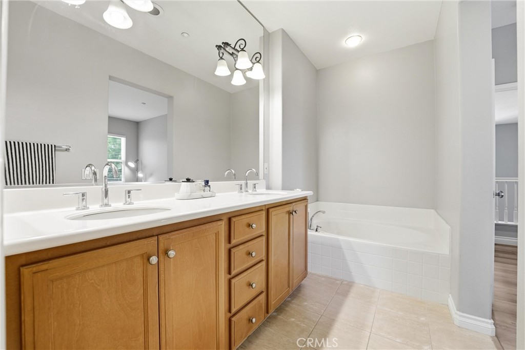 143 Lockford Irvine, CA 92602 - Photo 25 of 43 a bathroom with a tub sink and mirror