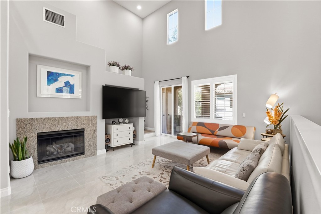143 Lockford Irvine, CA 92602 - Photo 5 of 43 a living room with furniture a flat screen tv and a fireplace