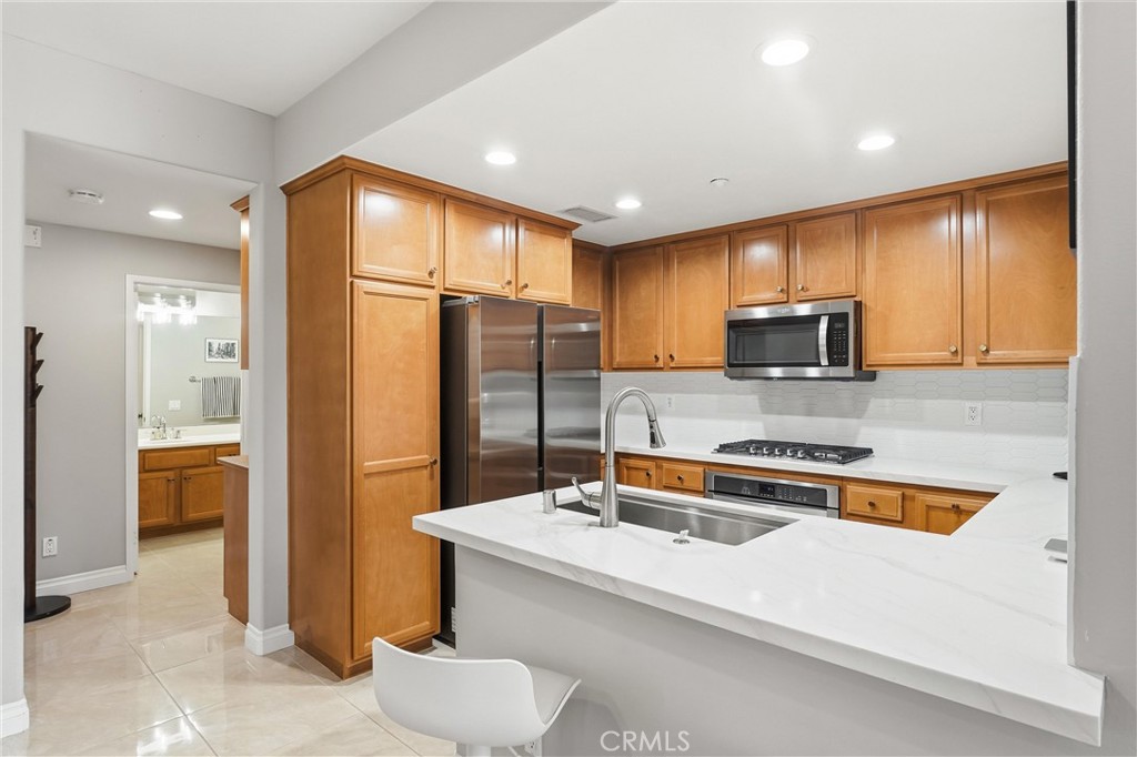 143 Lockford Irvine, CA 92602 - Photo 10 of 43 a kitchen with stainless steel appliances a refrigerator a sink a stove and cabinets