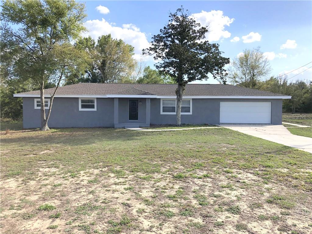 2306 Grant Road Lake Wales, FL 33898 - Photo 1 of 1 a front view of a house with a garden