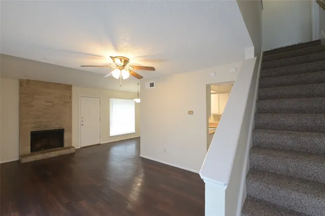 wooden floor in an empty room with a fireplace