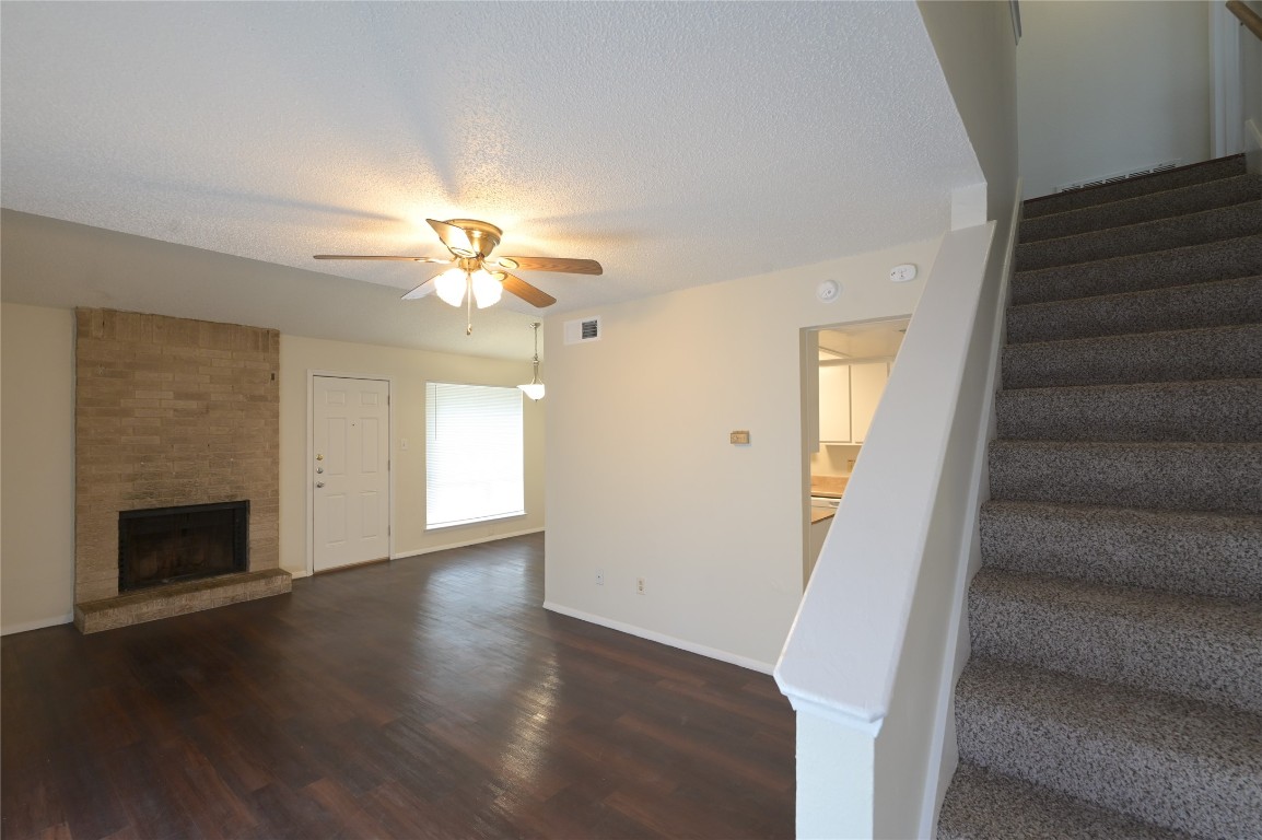 wooden floor in an empty room with a fireplace