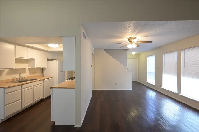 a view of a kitchen with a sink dishwasher and a fireplace