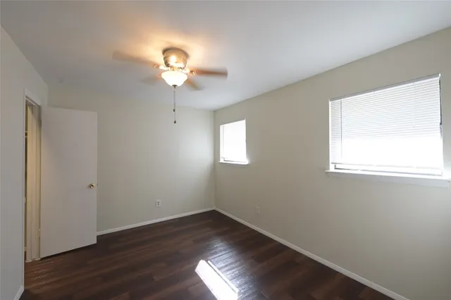 a view of room with window and wooden floor