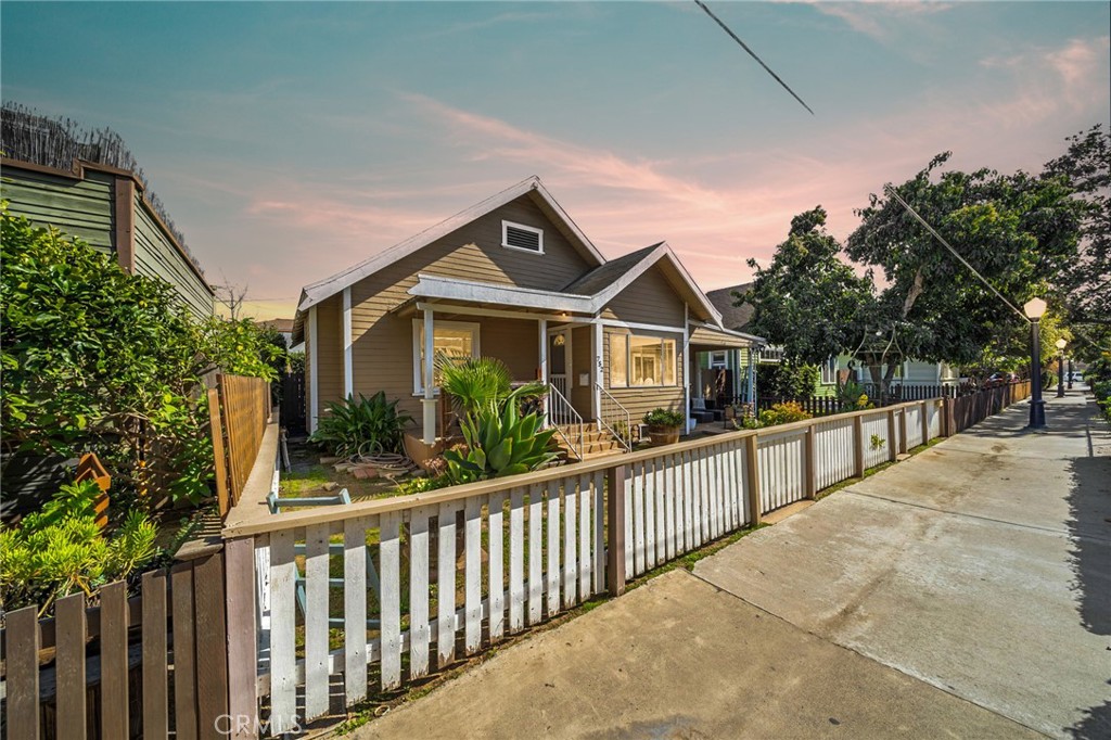 a front view of a house with wooden fence